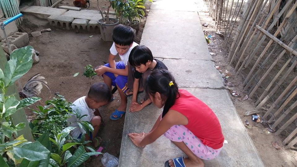 Children playing in the mud at Sitio Kasagingan Tanjay City