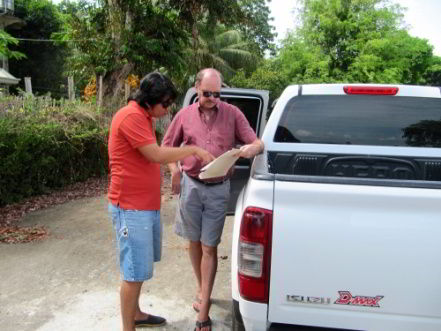 Examining plans for Casa Esperanza of Angels orphanage with Architect Rainier Garcia.