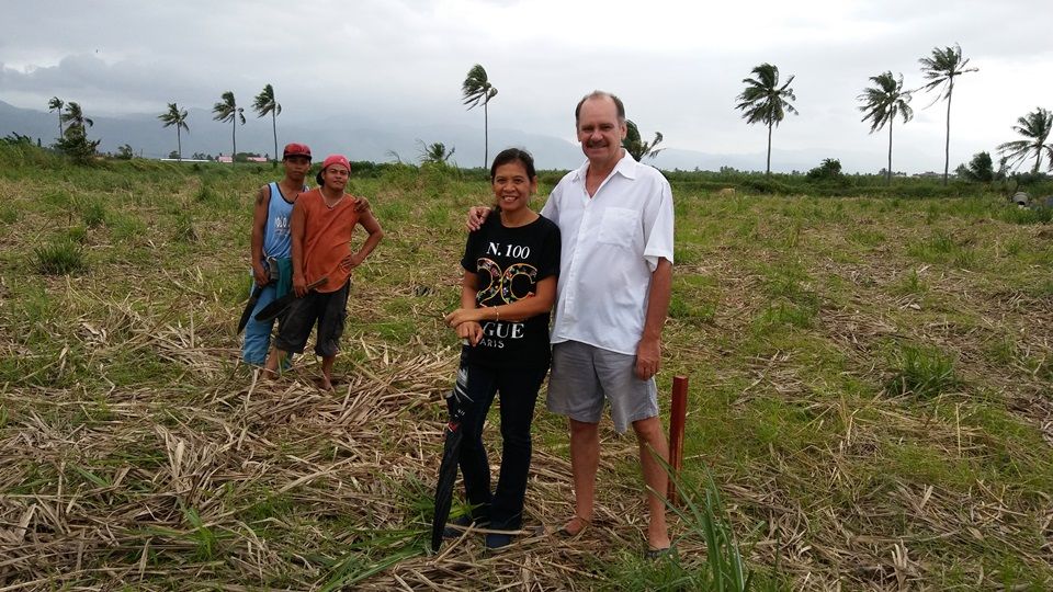 Ron & Gigi Brown with a couple of workers clearing the land and putting up markers for the buildings.